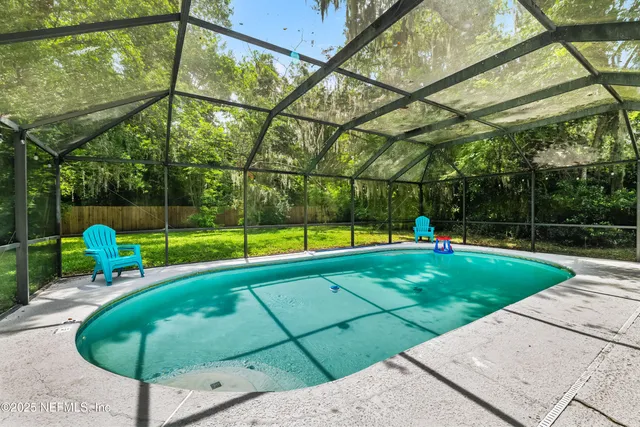 a view of a tennis court with a small yard