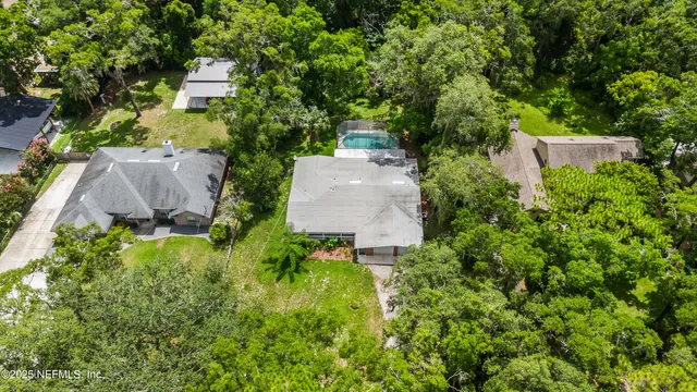 an aerial view of a houses with yard and lake view