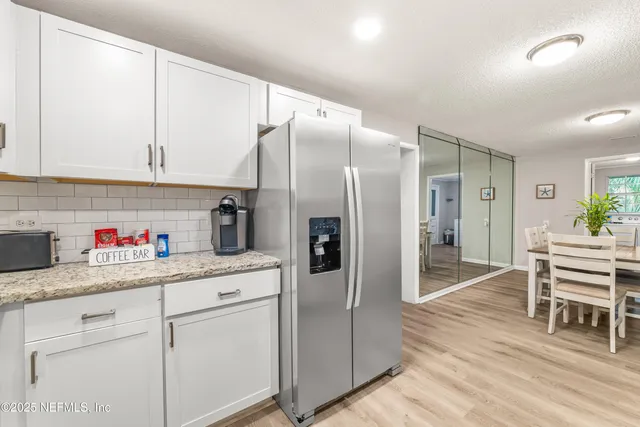 a kitchen with a refrigerator and cabinets