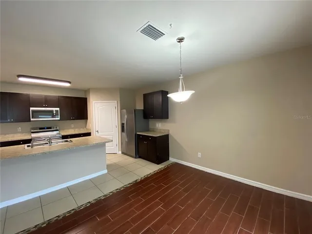 a kitchen with a sink and a stove top oven