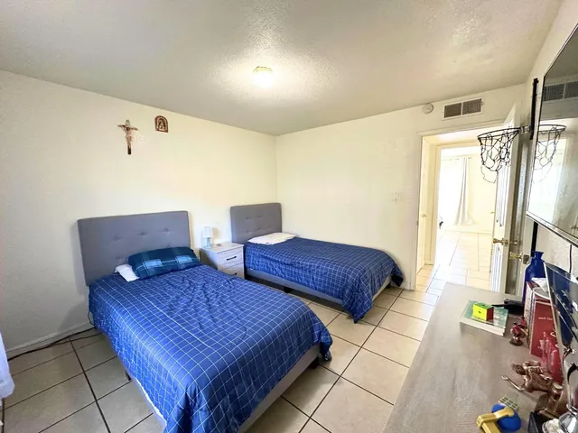 a bedroom with two beds and painting on the wall