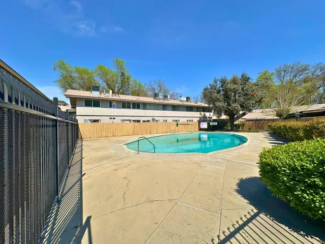 a view of a swimming pool with a yard