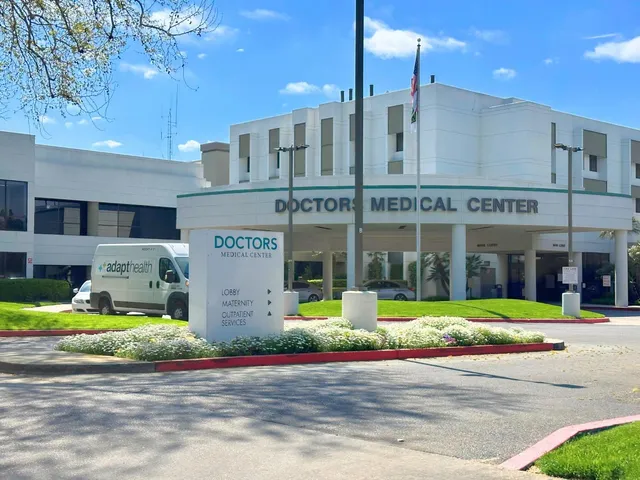 a front view of multi story building with retail shops