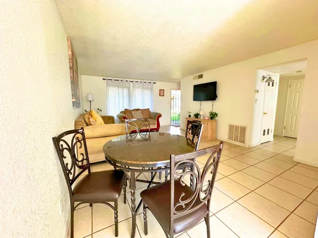 a dining room with furniture and wooden floor
