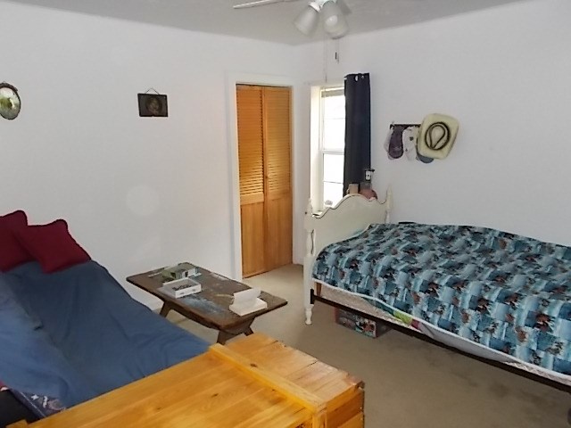 720 Grove Street Emlenton, PA 16373 - Photo 14 of 18 a bedroom with a bed and dresser with mirror