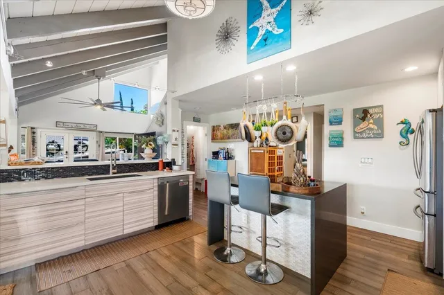 a kitchen with stainless steel appliances granite countertop a refrigerator and a stove