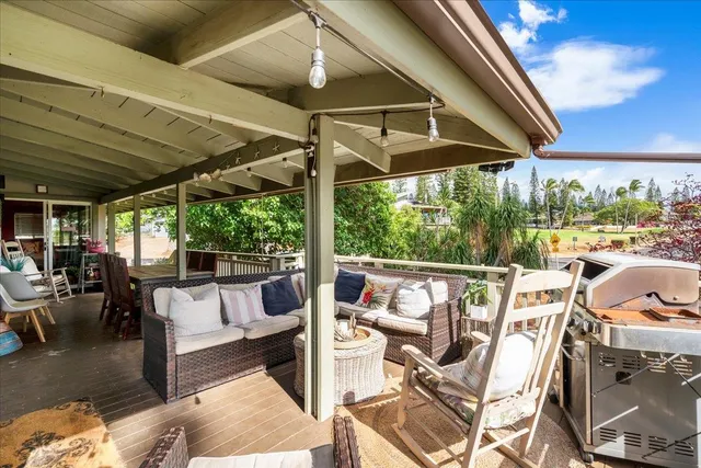 a view of a patio with chairs and table under an umbrella