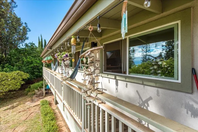 a view of balcony with wooden floor and fence and a potted plant