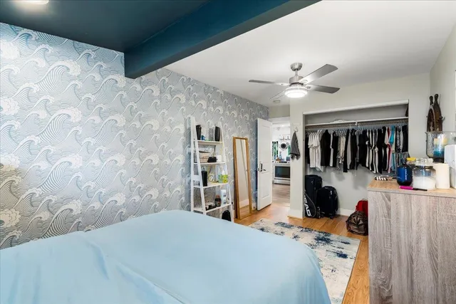 a bedroom with a bed and a walk in closet