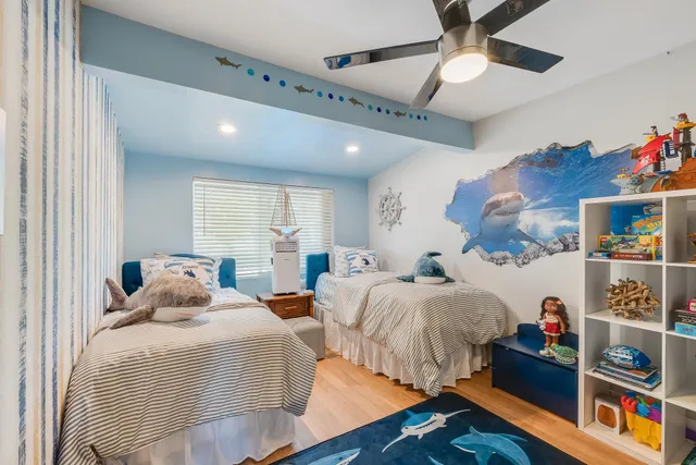 a bedroom with two beds and a window