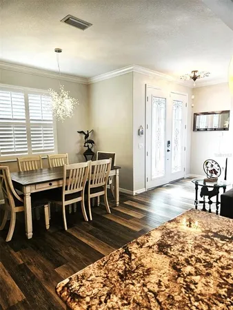 a kitchen with kitchen island granite countertop a sink and a stove