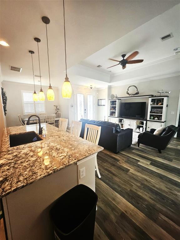 460 Marlin Road Venice, FL 34293 - Photo 18 of 44 a large kitchen with stainless steel appliances kitchen island granite countertop a sink a stove and a wooden floors