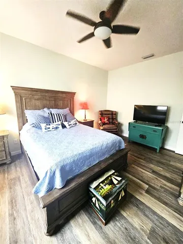 a bedroom with a bed and a night stand