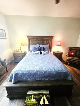 a large bed sitting in a bedroom next to a window