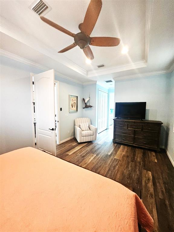 460 Marlin Road Venice, FL 34293 - Photo 30 of 44 a bedroom with a large bed and a flat tv screen on dresser