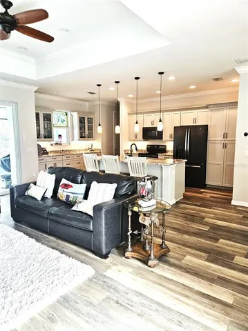 a living room with furniture and kitchen view