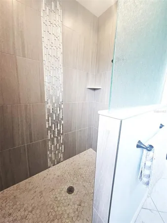a spacious bathroom with a double vanity sink and a mirror