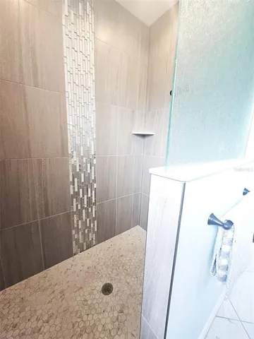 a spacious bathroom with a double vanity sink and a mirror