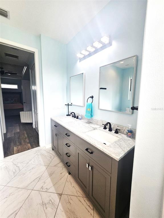 460 Marlin Road Venice, FL 34293 - Photo 35 of 44 a spacious bathroom with a double vanity sink and a mirror
