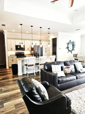 a living room with furniture kitchen view and a fireplace