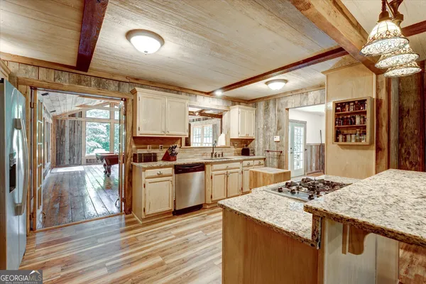 a kitchen with granite countertop cabinets stainless steel appliances and a counter top space