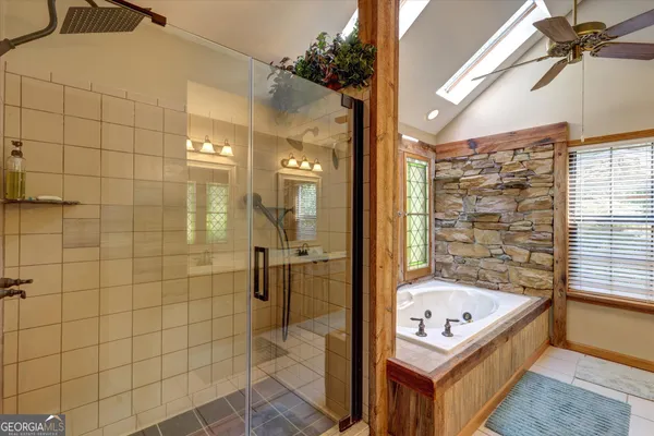 a bathroom with a tub and shower
