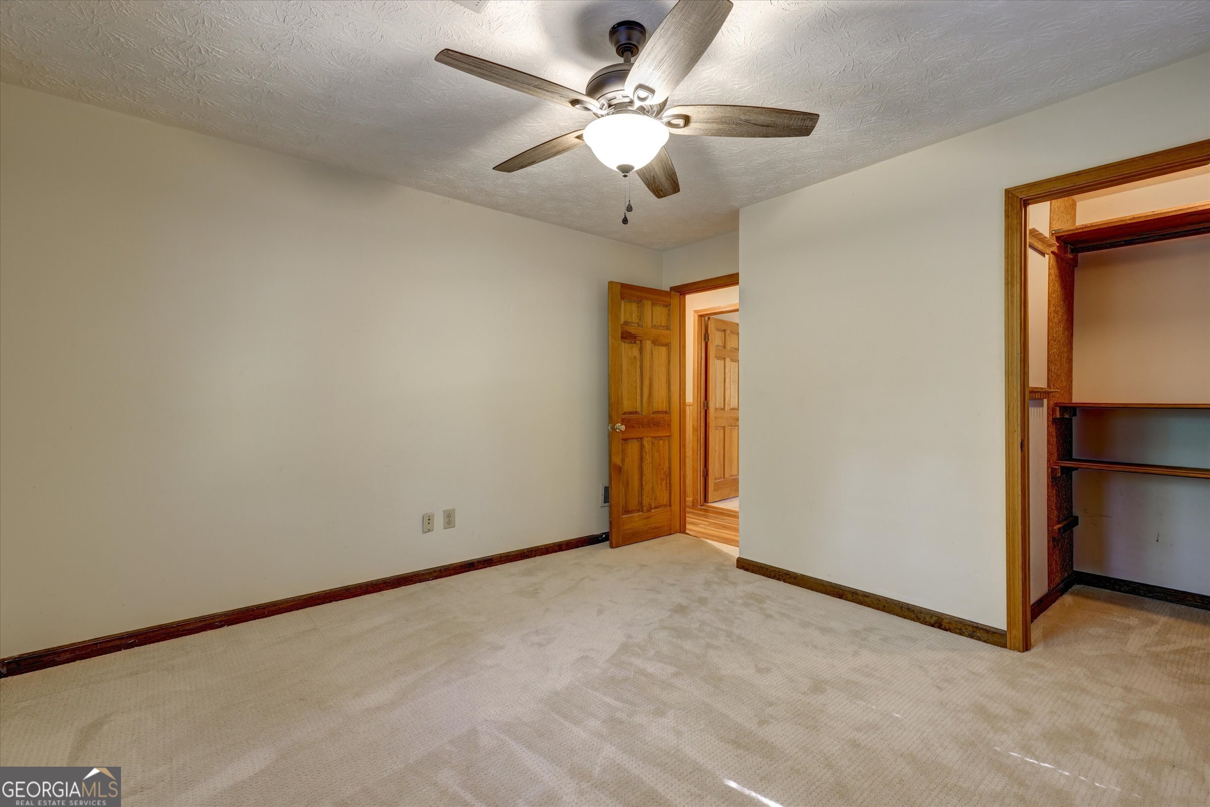 424 Hampton Road Hampton, GA 30228 - Photo 22 of 44 an empty room with closet and a ceiling fan