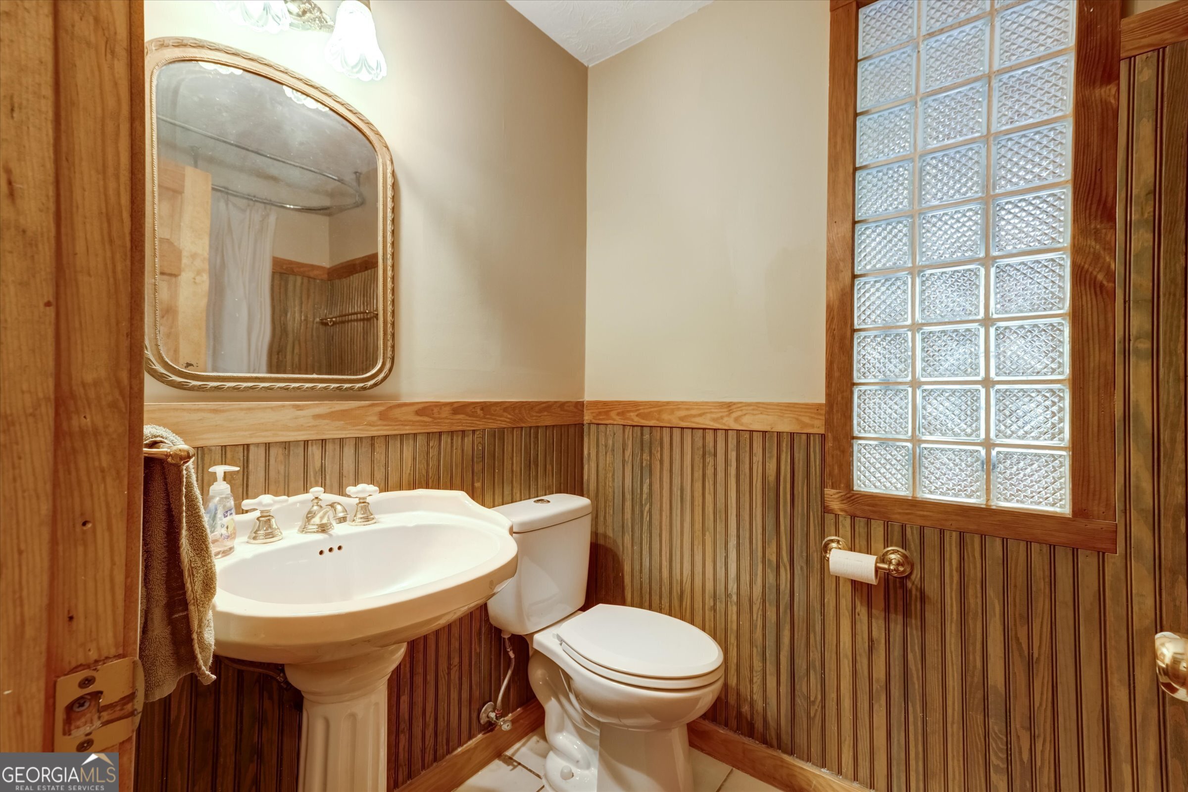 424 Hampton Road Hampton, GA 30228 - Photo 23 of 44 a bathroom with a sink toilet and mirror