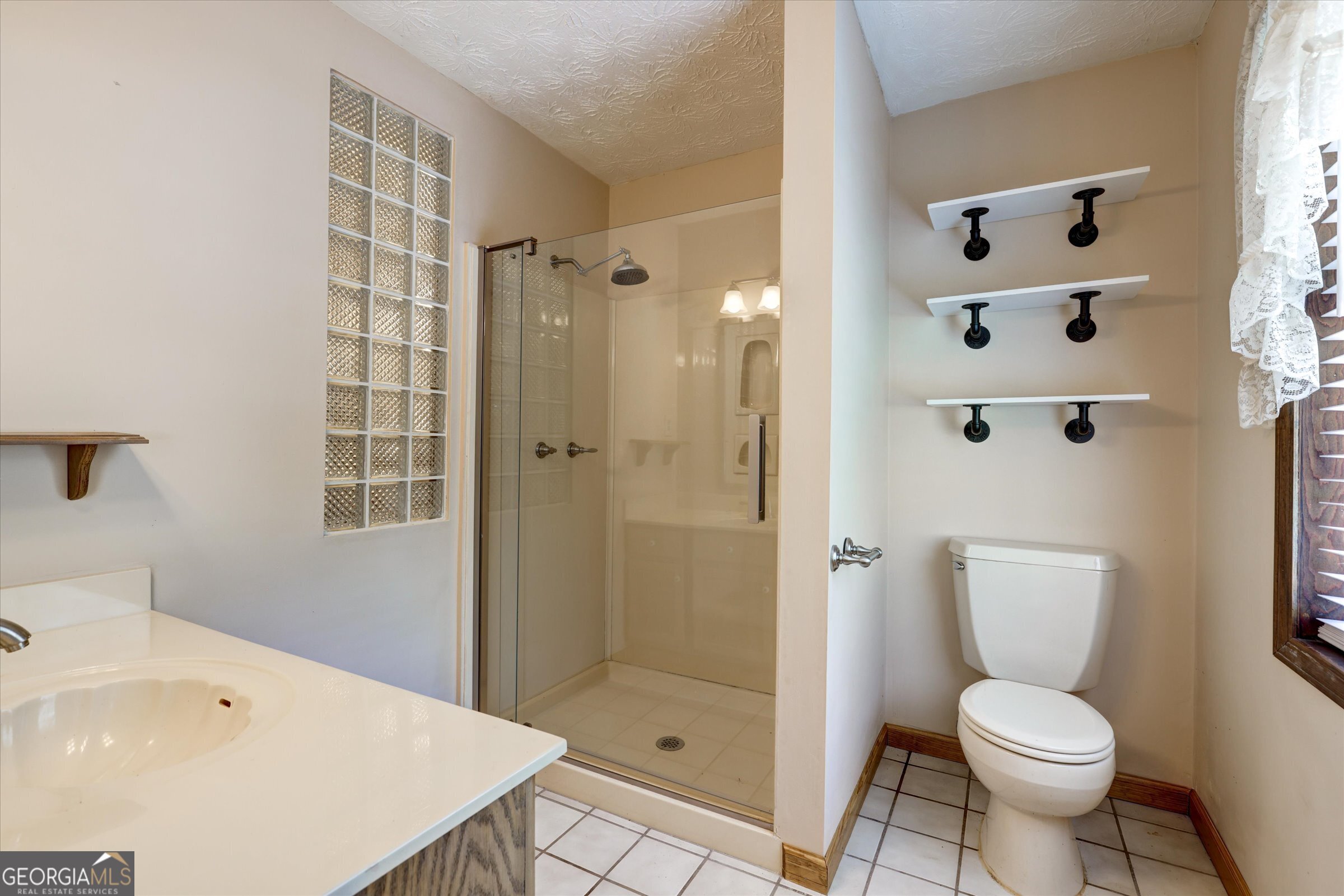 424 Hampton Road Hampton, GA 30228 - Photo 25 of 44 a bathroom with a sink toilet and shower
