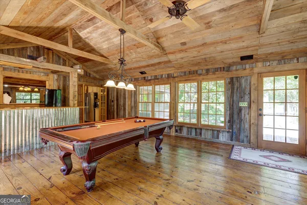 a room with pool table and windows