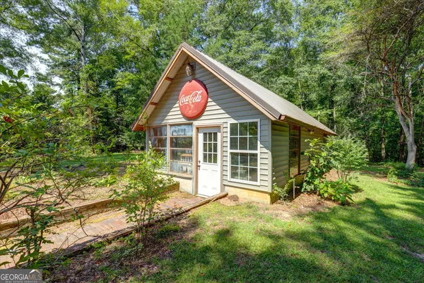 a view of backyard of house with wooden fence