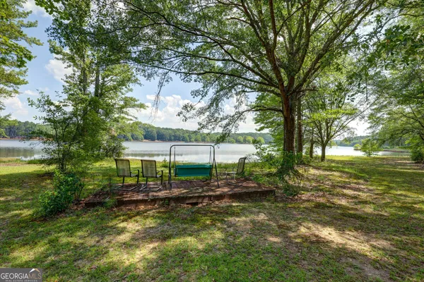 a view of a field with trees in the background