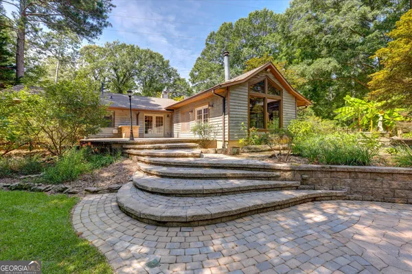 a front view of a house with a garden