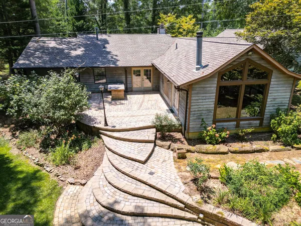 a view of a house with backyard and sitting area