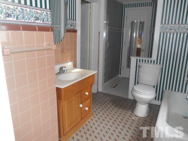 8040 Panther Lake Road Willow Spring, NC 27592 - Photo 8 of 14 a bathroom with a sink toilet and shower