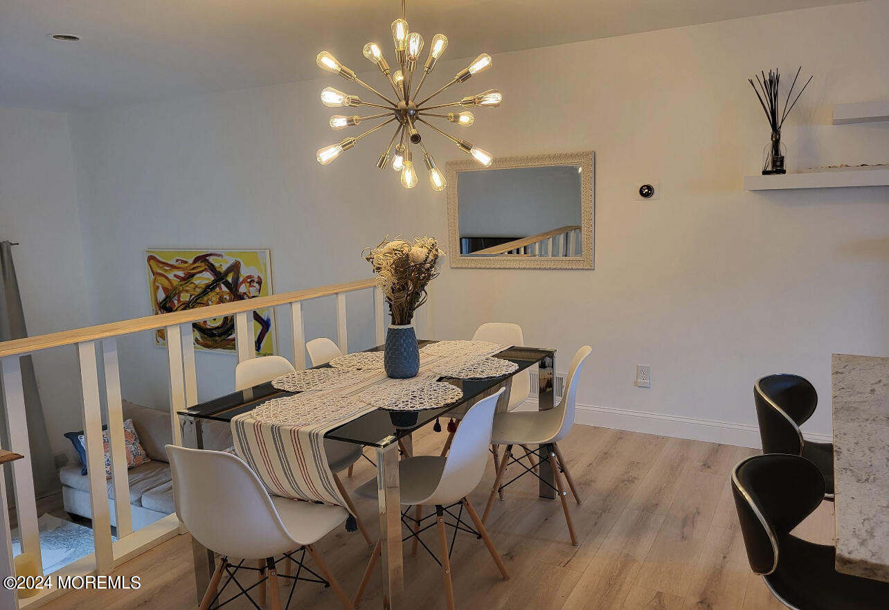 18 Village Road Sea Bright, NJ 07760 - Photo 8 of 29 a view of a dining room with furniture and wooden floor