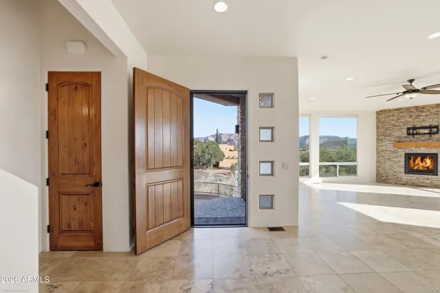 a living room with fireplace furniture and a large window