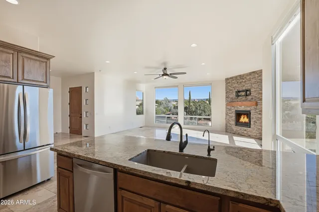 a spacious bedroom with a bed a couch and a potted plant