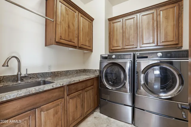 a view of a brick house with many windows and a yard