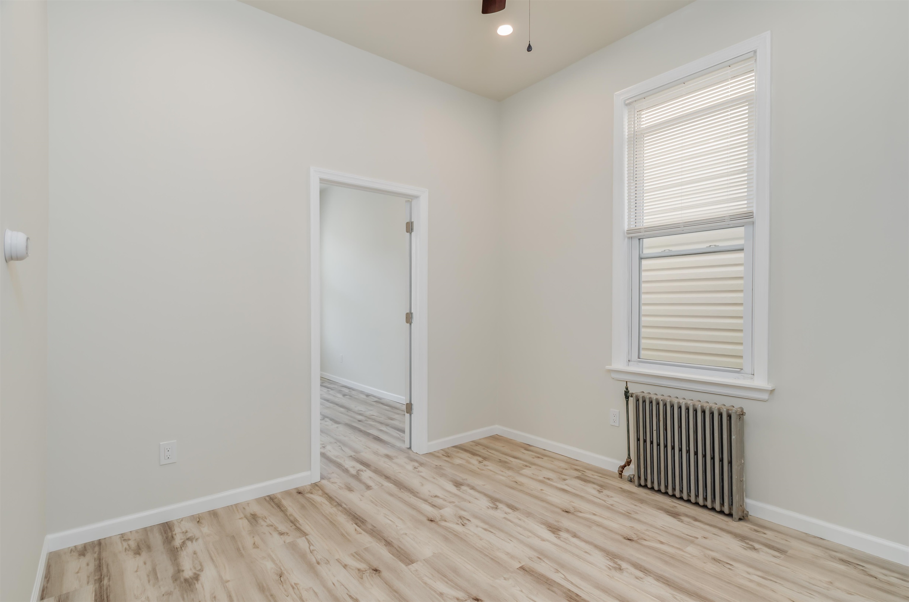 419 22nd Street, Unit 3 Union City, NJ 07087 - Photo 2 of 11 an empty room with wooden floor and windows
