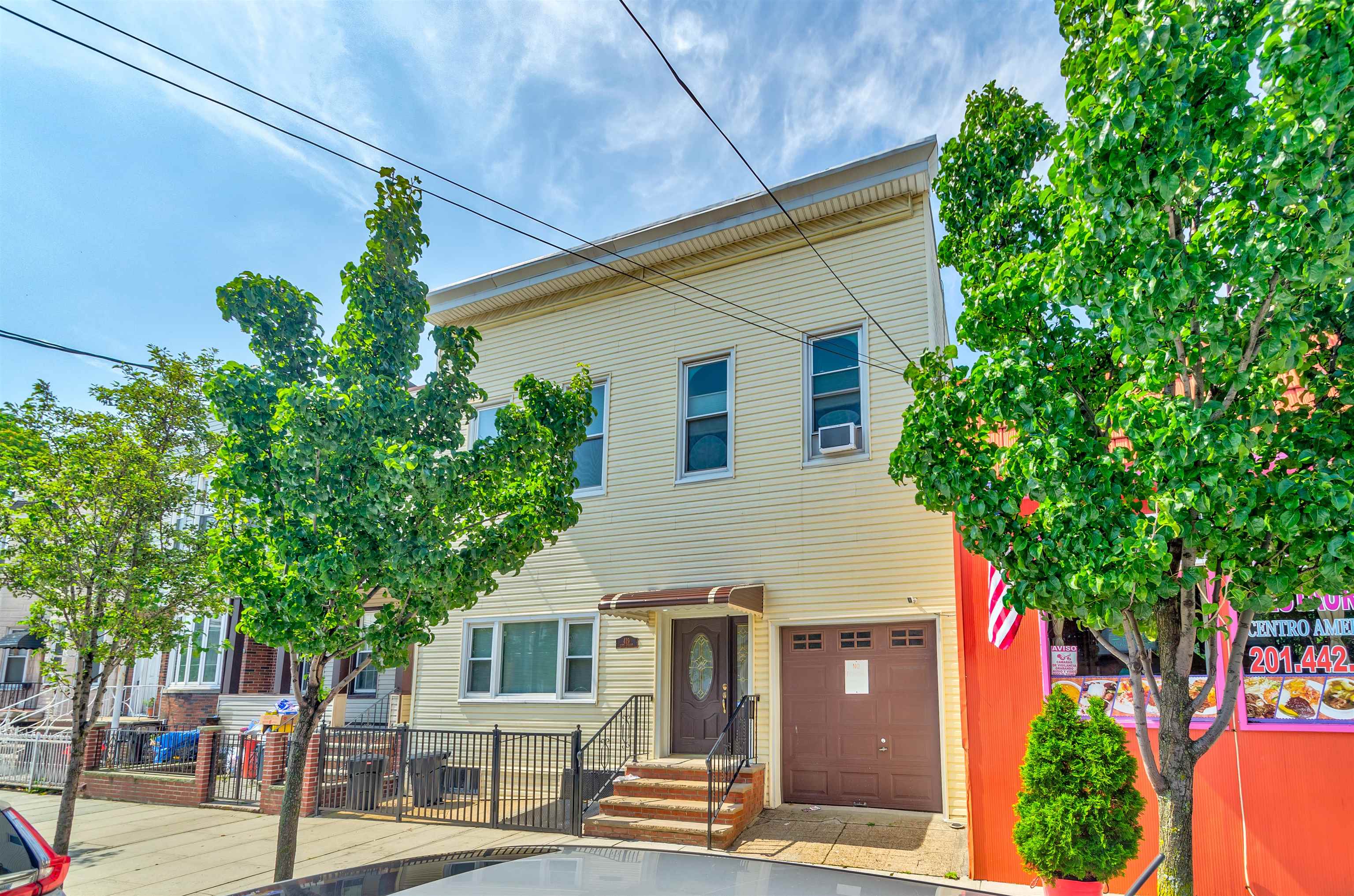 419 22nd Street, Unit 3 Union City, NJ 07087 - Photo 4 of 11 a front view of a house with a tree