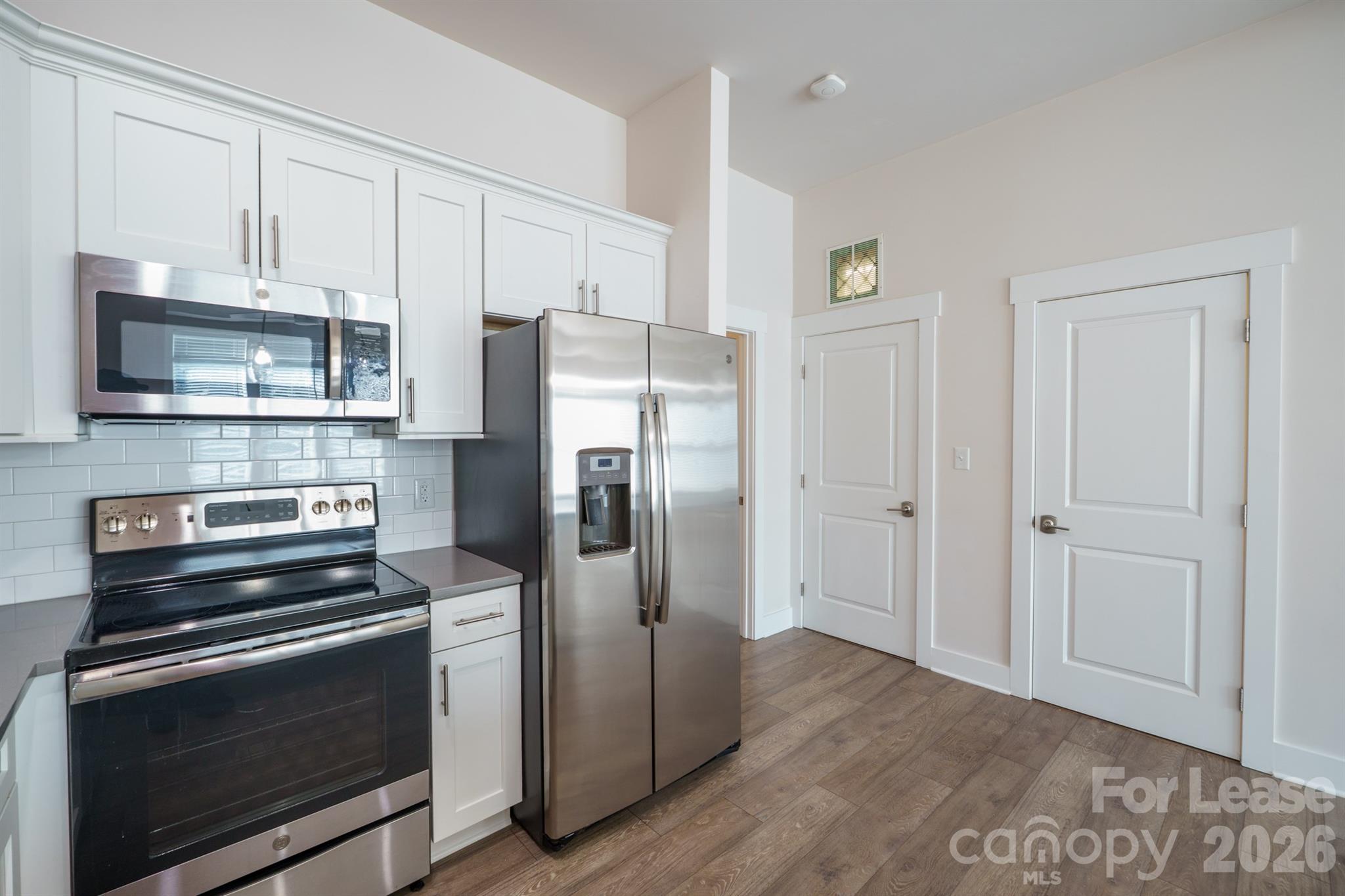 935 McAlway Road Charlotte, NC 28211 - Photo 11 of 21 a kitchen with stainless steel appliances a refrigerator stove and cabinets