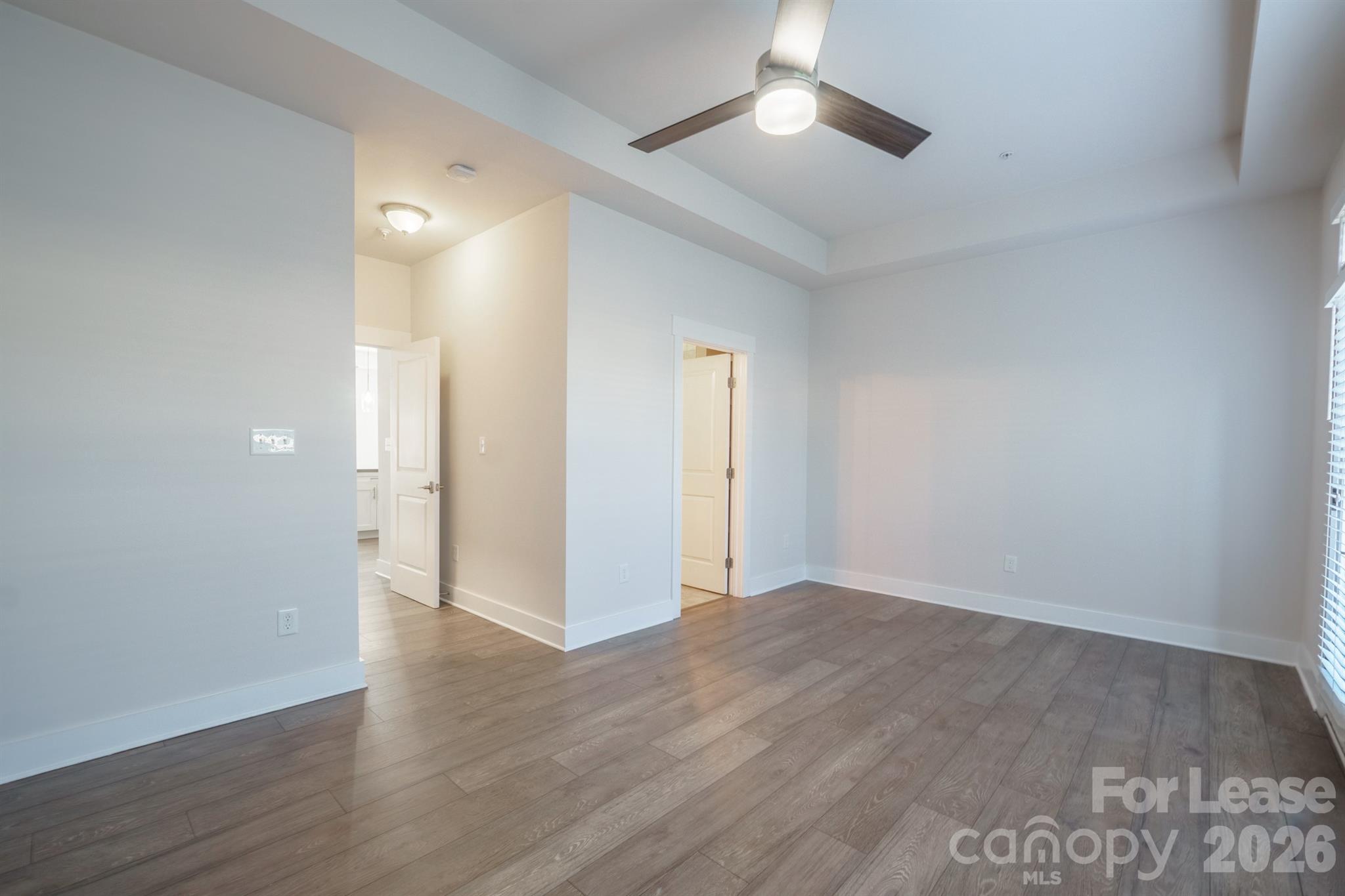 935 McAlway Road Charlotte, NC 28211 - Photo 15 of 21 an empty room with wooden floor and ceiling fan