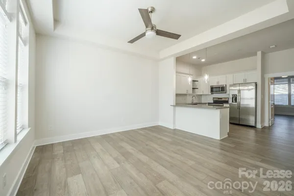 a view of kitchen with stainless steel appliances refrigerator stove microwave and cabinets