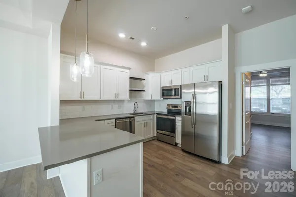 a kitchen with a refrigerator sink and cabinets