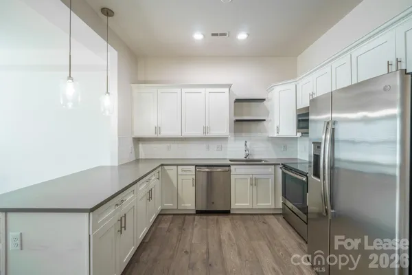 a kitchen with cabinets and stainless steel appliances