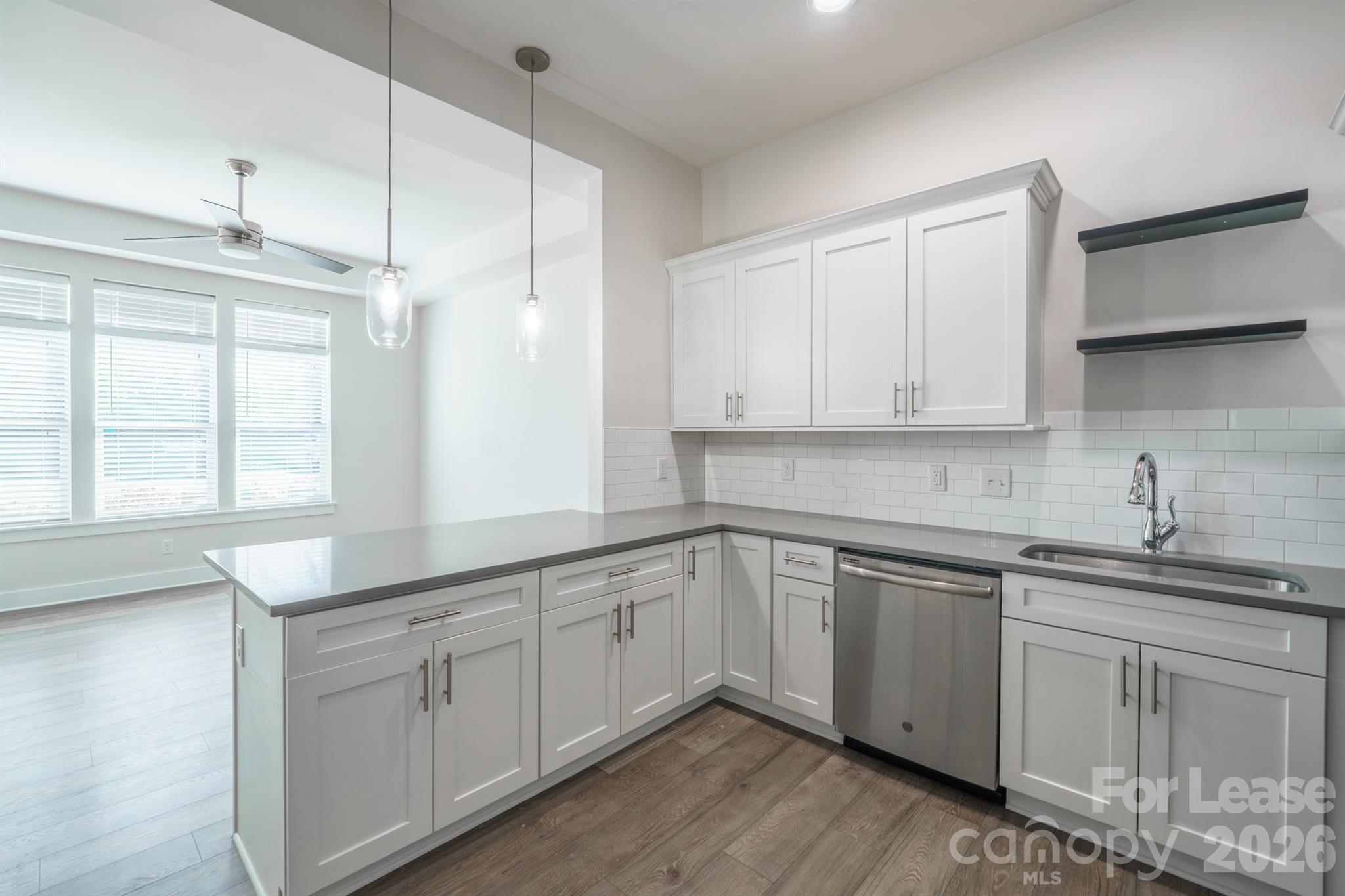 935 McAlway Road Charlotte, NC 28211 - Photo 10 of 21 a kitchen with white cabinets sink and window