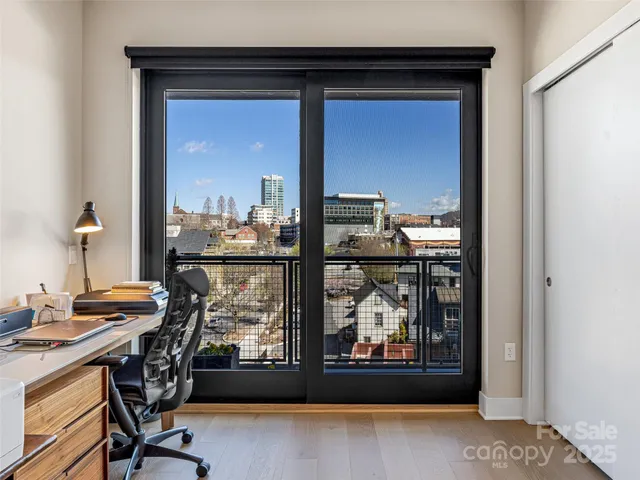 a view of a workspace with furniture and window
