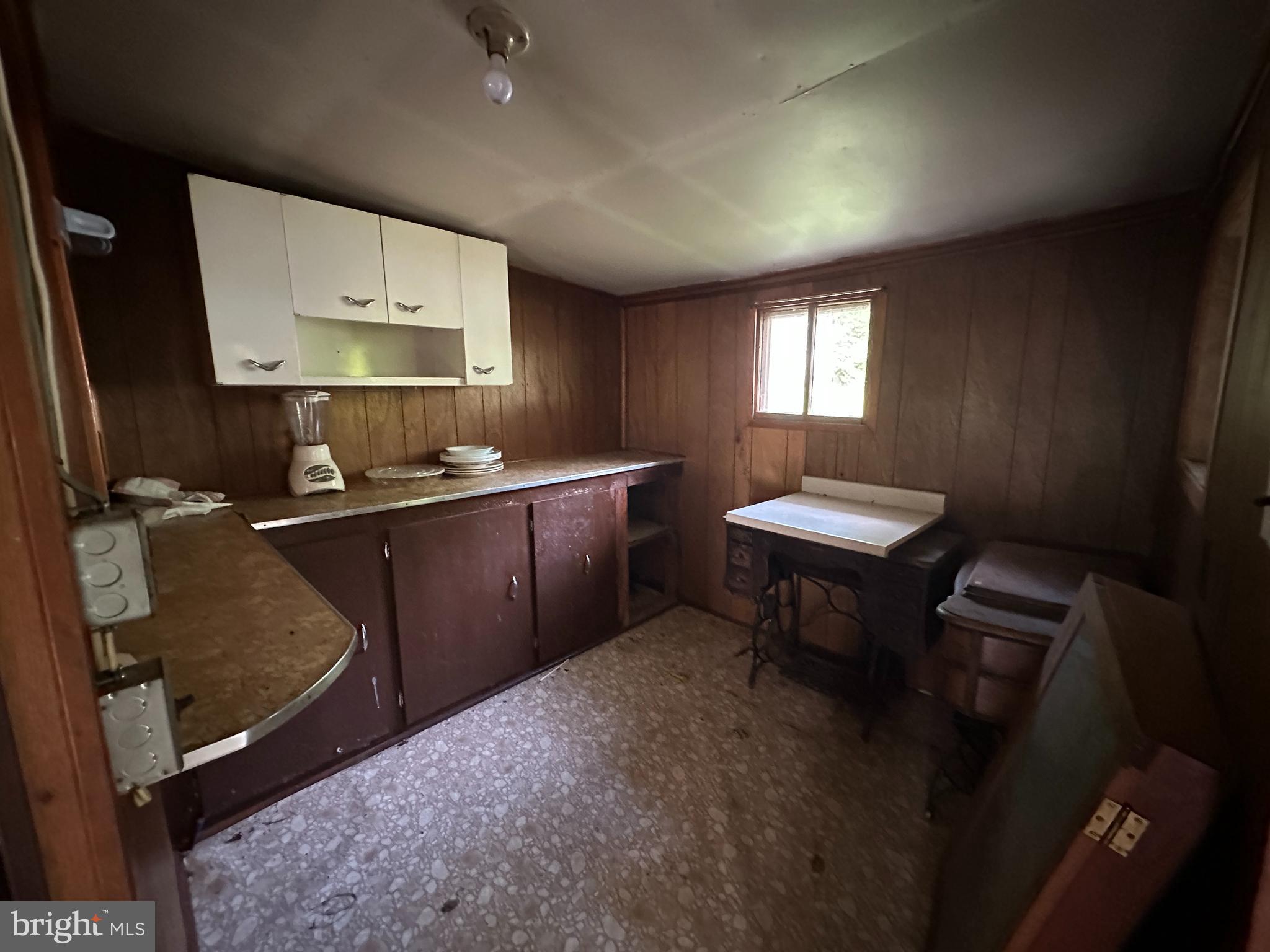 13726 Hopps Landing Road Hagerstown, MD 21740 - Photo 23 of 71 a kitchen with a sink a counter space and a window