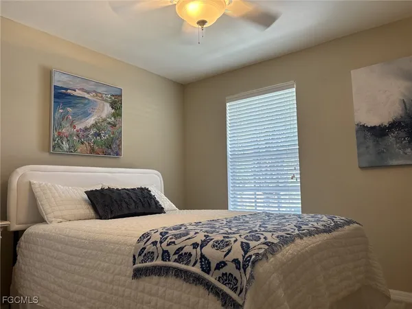 a bedroom with bed and a chandelier